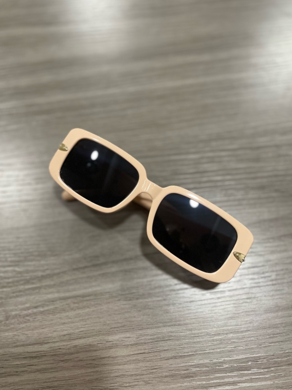 Blush pink square sunglasses with gold flower accents